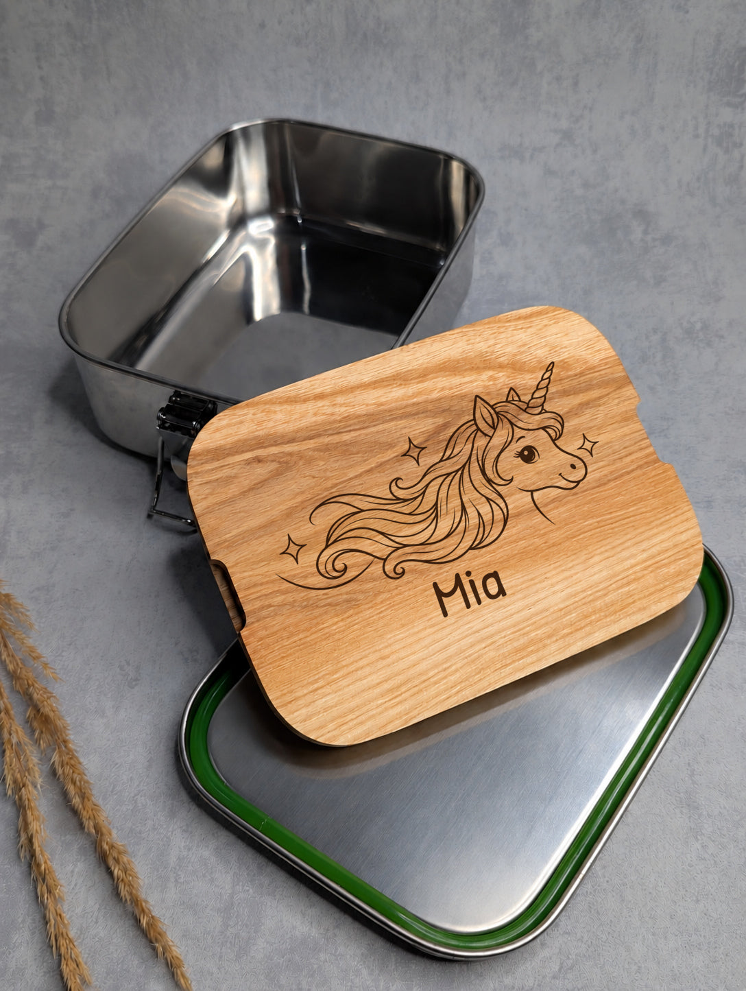 Geöffnete Edelstahl-Lunchbox mit Einhorn-Motiv und Beispielname Mia in Patrick Hand